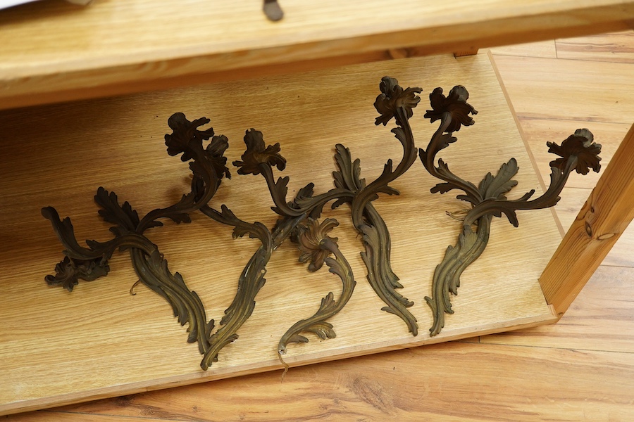 A set of four brass two branch wall scones, 37cm high. Condition - one branch broken.